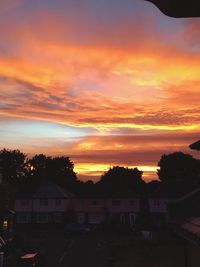 Silhouette of house against dramatic sky