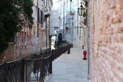 Narrow alley amidst buildings in city