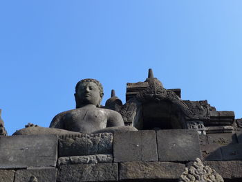 Low angle view of statue against clear blue sky