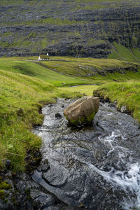 Scenic view of stream flowing through rocks