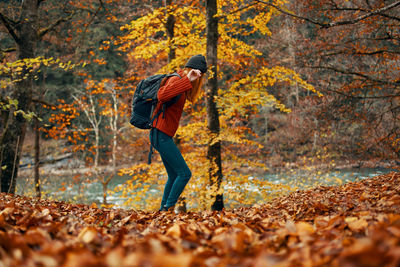 Full length of man standing by tree during autumn