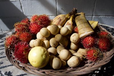 High angle view of rambhutan and fruits in basket