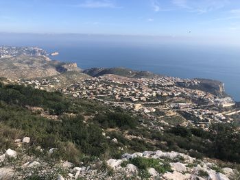 Scenic view of sea and mountains against sky