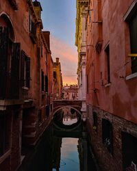 Bridge over canal amidst buildings in city