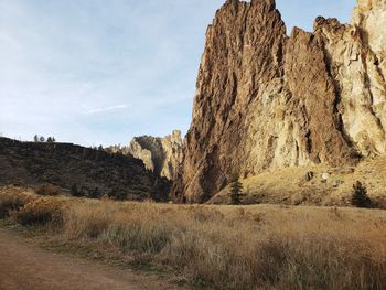 Rock formation on field against sky