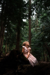 Young woman standing in forest