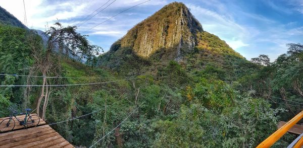 Scenic view of tree mountains against sky