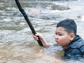 Close-up of boy swimming in river