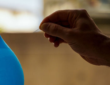 Close-up of hand holding leaf
