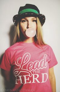 Portrait of a beautiful young woman blowing bubble gum over white background