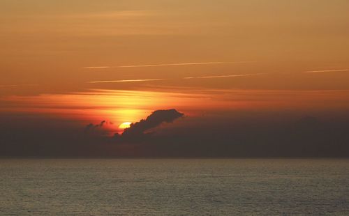 Scenic view of sea against romantic sky at sunset