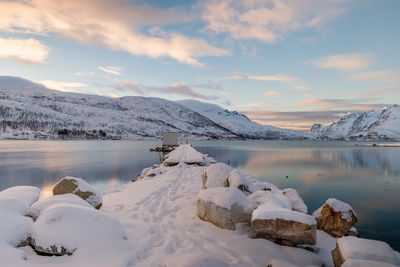 Scenic view of snowcapped mountains against sky during sunset