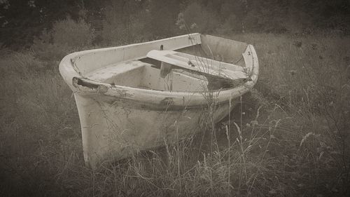 Abandoned boat on field