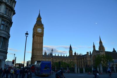 Tourists in front of building against sky