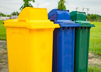 Close-up of garbage can on field