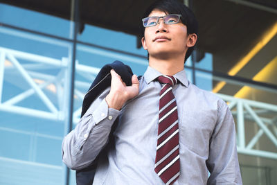 Businessman standing outside office building