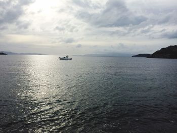 Lone boat in calm sea against sky