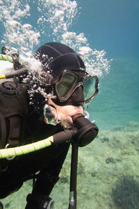 Woman scuba diving in sea