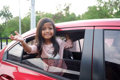 Portrait of young woman in car