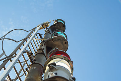 Low angle view of shoes against blue sky