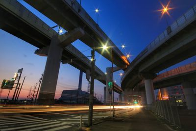 Low angle view of illuminated bridge against sky