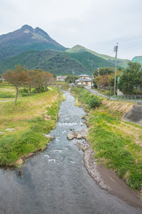 Road amidst green landscape against sky