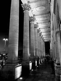 Low angle view of illuminated street lights at night