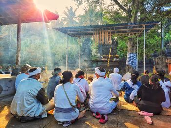 Rear view of people sitting in temple