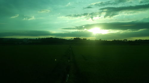 Scenic view of field against sky during sunset