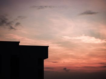 Low angle view of silhouette building against sky