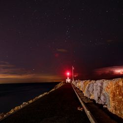 View of illuminated road at night