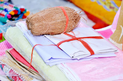 Close-up of coconut on stacked textiles