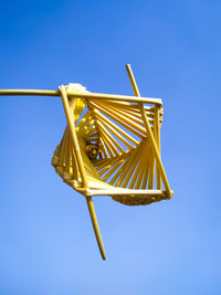 Low angle view of yellow structure against blue sky