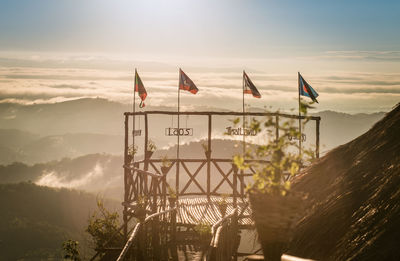 Low angle view of flags on mountain against sky