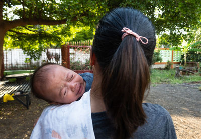 Portrait of couple kissing in park