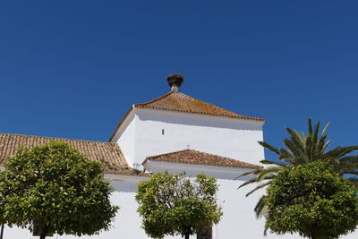 Parroquia del salvador in la villa, ayamonte view on church with stork nest and orange trees 