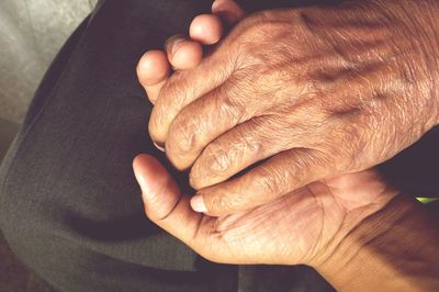 High angle view of senior couple holding hands