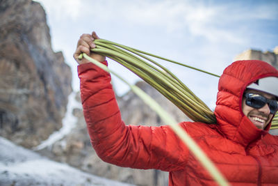 Man holding umbrella against sky during winter