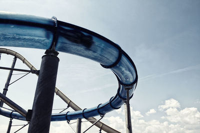 Low angle view of person in water slide against sky