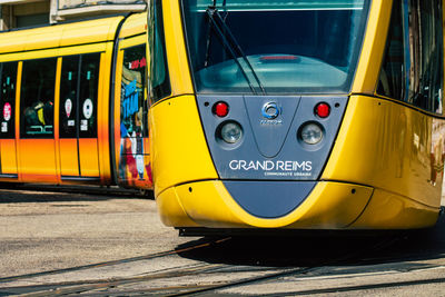 Yellow train on railroad track in city