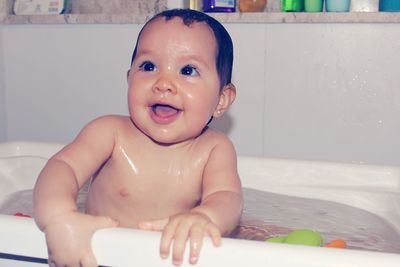 Portrait of cute baby girl in bathroom
