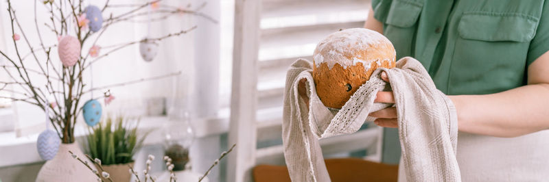 Happy easter holiday time in spring season. young housewife woman holds a freshly baked pastry cake