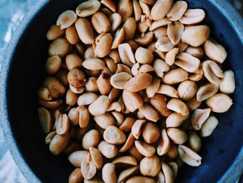 Overhead view of peanuts in bowl at table