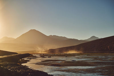 Scenic view of lake and mountains against clear sky