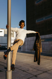 Full length portrait of young man in city