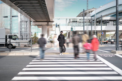 People walking on bridge in city