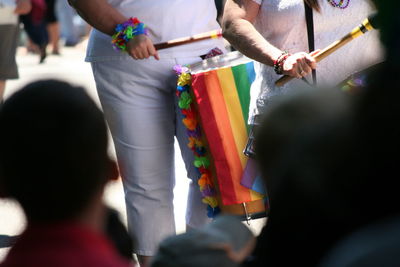 Midsection of people playing drum at gay pride parade
