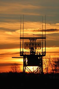Silhouette tower against sky during sunset