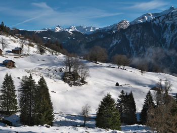 Scenic view of snow covered mountains against sky