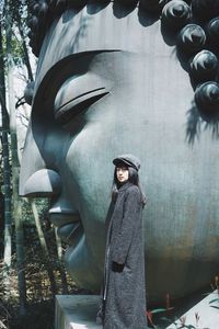 Portrait of young woman standing outdoors